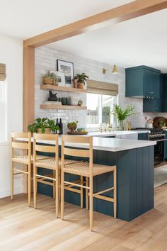 a kitchen with wooden floors and blue cabinets