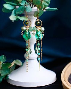 Green Jewelry With Dangling Charms As Gift, Green Jewelry With Dangling Charms For Gift, Emerald Dangle Jewelry For Gifts, Gift Drop Earrings With Dangling Charms, Gold Emerald Earrings For Gift, Handmade Emerald Earrings For Gift, Handmade Emerald Earrings As Gift, Emerald Dangle Earrings Gift, Artistic Single Earring For Gift