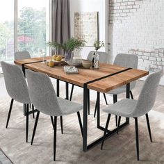 a dining room table with chairs around it and a brick wall in the back ground