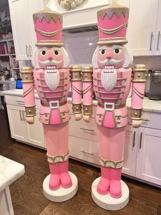 two large pink nutcrackers standing next to each other