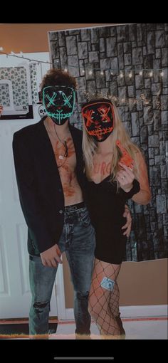 two people dressed up in costumes and masks