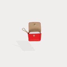 A detachable purse accent fused with practicality, the Avery AirPods Pouch is a patented solution to carrying your easy-to-lose AirPods in style. This red pebble leather clip-on pouch has a gold interior and features a lightweight fold-over snap closure. Add Avery to her Bandolier counterpart or mix and match for a fun new look! Red Pouch With Card Slots For Daily Use, Functional Red Pouch Bag, Red Crossbody Bag With Removable Pouch, Red Belt Bag With Removable Pouch, Red Bag With Removable Pouch For On-the-go, Gold Interior, Airpod Case, Mix N Match, Red Poppies