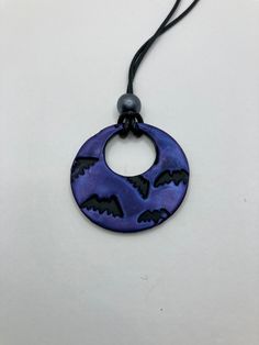 Black Polymer Clay with purple Mica Powder to shine. Pendant is 1 1/2 inches. Waxed cord is 16 inches in length. This Handmade necklace is perfect for Halloween. This necklace is fully hand made and hand finished so slight variations in color/finish should be expected. Mica Powder color will shine differently in different light. Purple Halloween Jewelry Gift, Gothic Purple Necklace For Halloween, Gothic Purple Jewelry For Halloween, Handmade Halloween Necklace, Clay Bat, Bat Pendant, Bat Necklace, Halloween Clay, Stamped Necklaces