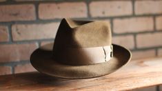 Handcrafted fedora inspired by the hat worn by Chris Cooper in Seabiscuit Originally custom made by Baron Hats Custom made to order, please allow 8-12 weeks for delivery. Store credit or exchange only. Crown: 4" Brim: 2.5" Color: Chocolate Brown Hatband: 2" chocolate brown grosgrain ribbon w/gentleman's bow * Disclaimer: "Seabiscuit", is TM and © (or copyright) by DreamWorks Pictures, Spyglass Entertainment, The Kennedy/Marshall Company, and Larger Than Life Productions. Any reproduction, duplic