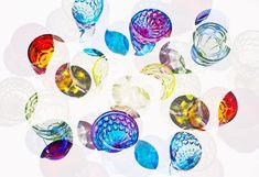 many different colored glass objects are arranged in a circle