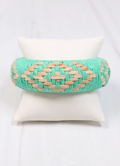 This bangle is so fun! It is wrapped with raffia and is woven with natural patterned accents for a bright look. One size. Bohemian Cuff Bracelet For Spring, Spring Bohemian Cuff Bracelet, Trendy Woven Braided Bracelet, Bohemian Braided Bangle Bracelet For Beach, Bohemian Braided Bracelet For The Beach, Handmade Bracelets For Spring Vacation, Beach Friendly Woven Friendship Bracelets, Woven Friendship Bracelets For Beach, Handwoven Summer Bracelets