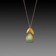 A magical faceted Ethiopian opal, wrapped in a warm 22k gold bezel is suspended from a 22k gold double leaf charm in this stunning necklace. The opal is backed with sterling silver, and measures approximately 1/2 inch tall. The leaf and opal together measure approximately 1 inch, and hang from a 14k gold chain. Matte finish. Ethiopian Opal Jewelry, Bezel Jewelry, Pink Sapphire Earrings, Ethiopian Opal Ring, Sparkly Jewelry, Tourmaline Jewelry, Moonstone Earrings, Leaf Necklace, Stunning Necklace