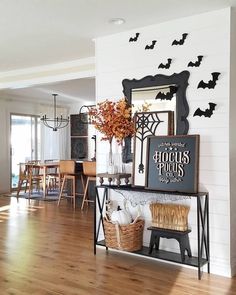 a living room filled with furniture and lots of bats hanging on the wall above it