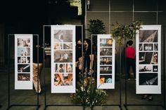 people are standing in front of several pictures on display at an art gallery with trees and plants