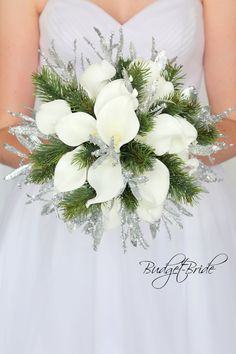 a bride holding a bouquet of white flowers