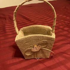 a small basket with a bow on the handle