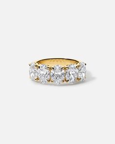 a yellow gold ring with five diamonds