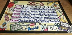 a table with a large calendar on it that says x - b and is decorated with school supplies