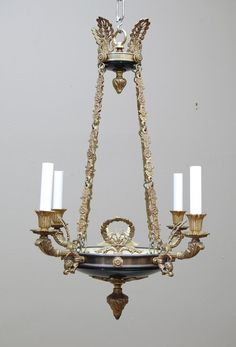 a chandelier with five candles hanging from it