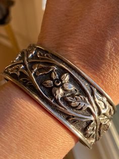 Slipada sterling silver retired Floral Vine Ornate Scroll Cuff bracelet Slipada retired sterling silver Clematic vine and leaves motif cuff bracelet in very nice pre-own condition.   Condition: very good as this is a pre-own item. Measures 2 .5" widest inside; open gap is about 1" inches open.   The band is about 1" inch tall. Total weight: 41.8  grams Bracelet is good for 7" to 7.5" wrist ( cuff can be slightly adjustable for better fitting due to sterling silver metal.) Hallmark: "925"  and Slipada hallmark inside side band's edge. The video and photos shown here are the actual items' pictures; please refer the video and all pictures to see the actual item's condition.  (Please do note that vintage items might sometimes might have that special age natural patina look due to they are old. Patina Jewelry, Cameo Brooch, Sterling Silver Cuff Bracelet, Wrist Cuffs, Floral Vine, Sterling Silver Cuff, Bangles Jewelry, Dream Jewelry, Vintage Bracelets