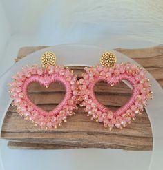 two pairs of pink beaded heart shaped earrings