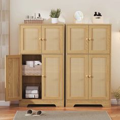 a wooden cabinet with two doors and some baskets on top of it in a living room