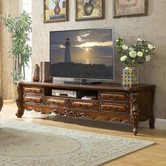 a living room scene with focus on the tv and flowers in front of the window