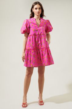 You'll be an oh-so-sweet sight to see in the Tune Floral Jeanne Bubble Sleeve Babydoll Dress! A cute pink and floral design decorate the puff sleeves around the shoulders and three layers of tiers which complement the dress. A split neckline is highlighted by billowy short sleeves in this mini dress. Perfect dress to take on your next vacation!- Split neckline- Bubble sleeves- Babydoll- Pocket- Color: Fuchsia Orange MulSize + Fit - Model is 5'8" and wearing size XS- Measurements taken from size Playful Pink V-neck Dress, Cute Pink Puff Sleeve Mini Dress, Sweet Pink Dress For Brunch, Playful Floral Print Mini Dress For Spring, Playful Floral Print Mini Dress, Playful Pink Dress For Brunch, Sweet Floral Mini Dress For Spring, Playful Short Sleeve Dresses For Brunch, Playful Pink Mini Length Dress