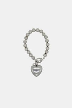 Estelle Bracelete is Y2K inspired perfection. Ideal addition to any outfit that will make it shine! Content + Care u00a0 Platted high quality plastic u00a0 Heart shaped charm and irregular stainless steel clasp. u00a0\- Made in USA u00a0 Size + Fit u00a0 Length: 15 cm or 6 inch | Velvet Luna Y2K Estelle Heart Bracelet in Silver, Women's at Urban Outfitters Metal Heart-shaped Beaded Bracelets For Valentine's Day, Heart-shaped Metal Beaded Bracelets For Valentine's Day, Metal Heart-shaped Beaded Bracelet For Valentine's Day, Necklaces Stacked, Stacked Rings, Dainty Necklaces, Bracelet In Silver, Heart Bracelet, Dainty Necklace