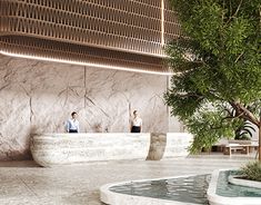 two people are standing in front of a tree and water feature at the entrance to an office building