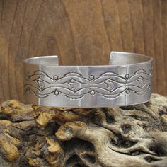 Vintage sterling silver cuff bracelet with intricate stamped designs. The inside measurement of the bracelet is 5 3/4" and then there is an additional 1" gap. This piece is 3/4" wide and weighs 32.7 grams. It is not stamped with the artist's hallmark but it is stamped "sterling". Thank you for looking at this bracelet, please message us with any questions. Southwestern Style Stamped Sterling Silver Bangle, Southwestern Style Stamped Sterling Silver Bangle Bracelet, Southwestern Sterling Silver Stamped Bangle Bracelet, Southwestern Stamped 925 Cuff Bangle Bracelet, Western Silver Concho Cuff Bracelet, Western Silver Cuff Bracelet With Concho, Silver Western Cuff Bracelet, Southwestern Silver Stamped Cuff Bracelet, Western Style Stamped Cuff Bracelet