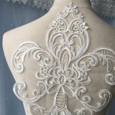 the back of a mannequin with white lace on it