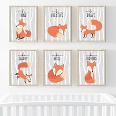 four fox prints hanging on the wall next to a crib in a baby's room