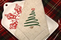 a white plate topped with a christmas napkin