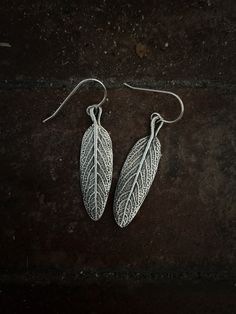 Sage leaf earrings, made from the sage growing in my garden in Vermont. You can almost smell it! Earrings are made of pure silver (999) and hand on sterling silver ear wires. They are approximately 1.5" long and with the ear wire hang approximately 2" from the ear. The raised areas are polished silver while the recessed areas have a dark patina that accentuates the texture and makes them come alive. It takes me approximately 10 days to create and ship your piece, as I handmake each one. Sage Leaves, Silver Snake Chain, Polish Silver, Rolo Chain, Ear Wires, Ear Wire, Snake Chain, Leaf Earrings, Pure Silver