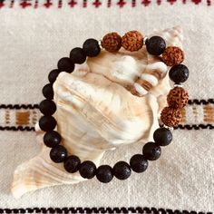 The Rudram Wrist Mala was designed to reflect earth colors . The combination of Lava Rocks, Rudraksha seeds and tiny silver Hematite beads are a winning of choice of earth colors and grounding energy. - Lava Rock is known to be a grounding stone that strengthens one's connection to Mother Earth. It activates courage and provides stability through times of change. - Rudraksha is the seed of a broad-leafed evergreen tree found mainly in the Himalayan foothills. It is believed that wearing these be Spiritual Brown Beaded Bracelets, Spiritual Jewelry With 108 Beads For Everyday, Everyday Spiritual Jewelry With 108 Beads, Holistic Beaded Bracelets With Round Beads For Meditation, Spiritual Brown Bracelet For Meditation, Earthy Hand-strung Beaded Bracelets For Everyday, Brown Spiritual Bracelets For Meditation, Spiritual Hand Wrapped Beaded Bracelets For Meditation, Spiritual Hand-wrapped Beaded Bracelets For Meditation