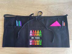 a black bag with crayons and markers on it