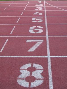 a red running track with numbers painted on it