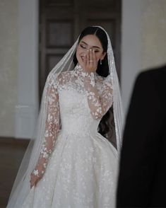 a woman in a white wedding dress standing next to a man