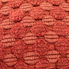 the texture of red knitted material is very close up and looks like it could be used