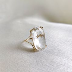 This stunning ring is set in 14K solid yellow gold with Natural Clear Quartz gemstone. It is a great addition to your ring collection and is completely hassle-free jewelry. ✓ ITEM DETAILS * Gem: Clear Quartz * Gem Size: 12x20mm * Gem Shape: Cushion * Gem Weight: 11.7 carats * Gold purity: 14K * Gold weight: 1.53 grams * Gross weight : 3.87 grams The Gold purity is guaranteed and it comes with authentic 14K gold hallmark. Since these Rings are handmade, they are Nickel/Lead FREE. ✓ CUSTOMISATION Modern Yellow Gold Rings With White Topaz, Luxury Yellow Gold Crystal Ring With Gemstone, Luxury 14k Gold Diamond Ring With Si Clarity, Timeless 14k Gold Crystal Ring For Gift, 14k Gold Crystal Ring As Gift, Modern 14k Gold Crystal Ring For Formal Occasions, Luxury Gold Diamond Ring With Si Clarity, Yellow Gold Rings With Si Clarity And Round Cut, Modern Oval White Topaz Ring