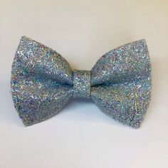 Add some shimmer to your life with this incredibly shiny bow. The silver holographic glitter reflects multiple colors so it will match almost any outfit. It clips simply into any hair with an alligator clip on the back. The glitter does not flake off easily because no one likes the mess of loose glitter! The bow measures approximately 3.5 x 2.25 inches. --- *Thank you for supporting my dream! *If you are unsatisfied in any way, please contact me before leaving a review to find a resolution. *If you love your product feel free to give me 5 stars or share my shop. *Product care tip: As with any novelty jewelry or accessory, do not get it wet or leave it out in the sun. *Don't hesitate to ask if you have any questions. Silver Holographic, Loose Glitter, Glitter Hair, Winston Salem, Holographic Glitter, Barrette Clip, My Dream, Barrettes, Love Your