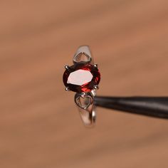 It is natural garnet ring. The main stone is 7mm*9 mm oval cut.weight about 2.33 carats.The basic metal is sterling silver and plated with rhodium.To change the metal to a solid gold (white/rose) or platinum is also available, please ask for a quotation if you want.You can also go to my shop Home for more elegant rings: https://www.etsy.com/shop/godjewelry?ref=hdr_shop_menu Emerald  is January birthstone More garnet rings:https://www.etsy.com/shop/godjewelry?ref=l2-shopheader-name§ion_id=2070924 Oval Ruby Solitaire Jewelry, Oval Garnet Birthstone Ring, Silver Garnet Jewelry With Prong Setting, Elegant Heart Cut Ruby Ring In Sterling Silver, Elegant Oval Garnet Birthstone Ring, Silver Oval Garnet Birthstone Ring, Oval Silver Garnet Birthstone Ring, Oval Garnet Birthstone Ring In Silver, Oval Garnet Rings