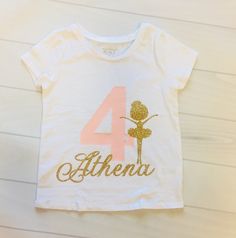 This shirt is perfect for any Ballerina themed Birthday. Made with our beautiful no shed glitter its sure to be a hit! We offer design color changes upon request. Please add Child's name into the order notes Shirt: The Children's Place (100% Cotton) Washing Instructions: Turn inside out, wash on a cold cycle, tumble dry low or hang to dry. Don't forget to LIKE us on Facebook! {https://www.facebook.com/Paytonspinkboutique/} **Tutu {If ordering the SET How to order: Please add size and name into o Fitted Top With Name Print For Birthday, Customizable Fitted T-shirt For Birthdays, Customizable Fitted T-shirt For Birthday, Pink Glitter Print Top For Birthday, Fitted Custom Print Tops For Birthday, Customizable Cotton T-shirt For Party, Gold Graphic Print Top For Birthday, Gold Top With Graphic Print For Birthday, Gold Top With Graphic Print