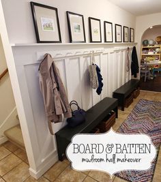 a coat rack and bench in a room with pictures on the wall above it, along with a rug