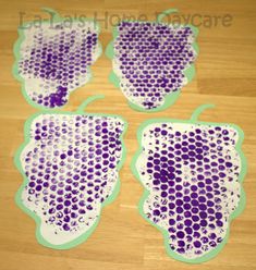 four pieces of purple and green paper with dots on them