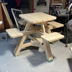 a wooden picnic table sitting in a garage