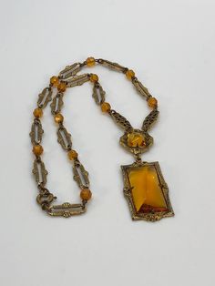 Beautiful Czechoslovakian style 1930-1940 amber colorded glass pendant on a detailed gold tone link chain with amber colorded crystal beads. Dress up or dress down this stunning piece; unmarked. Antique Amber Pendant Necklaces, Antique Amber Pendant Necklace, Vintage Beaded Antique Gold Necklace, Antique Gold Beaded Vintage Necklace, Vintage Amber Beaded Necklace, Vintage Gold Jewelry With Beaded Chain, Vintage Beaded Chain Necklace For Formal Occasions, Victorian Style Gold Beaded Necklace, Vintage Formal Beaded Chain Necklace