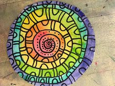 a colorful paper plate sitting on top of a wooden table