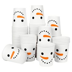 a group of white cups with orange faces and black dots on each cup are shown