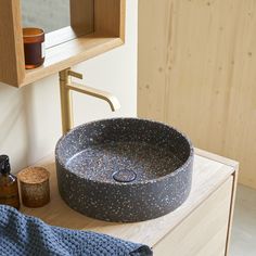 a bathroom sink sitting on top of a wooden counter