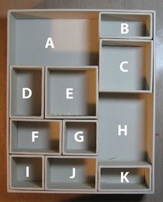 the letters and numbers are arranged in an open bookcase with compartments on each side