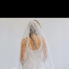 a woman in a white wedding dress with a veil on her head and the words love is written across it