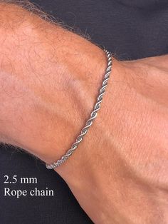 Stainless Steel Rope Chain in Silver Tone. Elevate your style with our men's silver-tone stainless steel chain bracelet. Crafted from durable stainless steel, this bracelet is resistant to corrosion and tarnish, ensuring long-lasting shine and reliability. Features: - Material: Stainless Steel - Color: Silver-Tone - Sizes: Available in various lengths for a perfect fit You can see our other bracelet designs here https://www.etsy.com/shop/TheUrbanMonarch?ref=l2-about-shopname&from_page=listing§ion_id=49985390 This bracelet is perfect for both everyday wear and special occasions, easily pairing with other accessories and jewelry. The secure clasp ensures comfort and safety. Add a touch of elegance and modern flair to your wardrobe with this versatile chain bracelet! How to Choose the Right S Mens Silver Bracelets, Silver Bracelets For Men, Silver Rope Bracelet, Bf Gifts, Mens Bracelet Silver, Men Bracelet, Simple Bracelets, Men's Bracelet, Silver Chain Bracelet