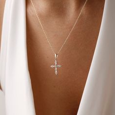 Add dainty to your combinations with our elegant Cross Necklace. Crafted with precision and care, this necklace features a delicate cross pendant adorned with sparkling pave crystals. The elegant design adds a subtle yet stylish accent to any outfit, making it perfect for everyday wear or special occasions. Made from high-quality materials, including durable metal and sparkling crystals, this necklace is designed to last. Its adjustable chain ensures a comfortable fit for everyone, while its tim Elegant Clavicle Chain Cross Necklace For Gift, Elegant White Cross Necklace With Adjustable Chain, Elegant White Crucifix Necklace, Wedding Clavicle Chain Necklace With Cross Shape, Elegant Cross Necklace With Adjustable Chain, Wedding Cross Necklace With Clavicle Chain, Elegant Silver Cross Necklace For Wedding, Elegant White Gold Cross Necklace With Adjustable Chain, Elegant Crucifix Necklaces With Adjustable Chain